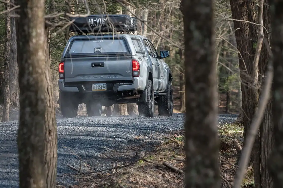 Rearview of the Tacoma driving down a gravel road Rearview of the Tacoma driving down a gravel road