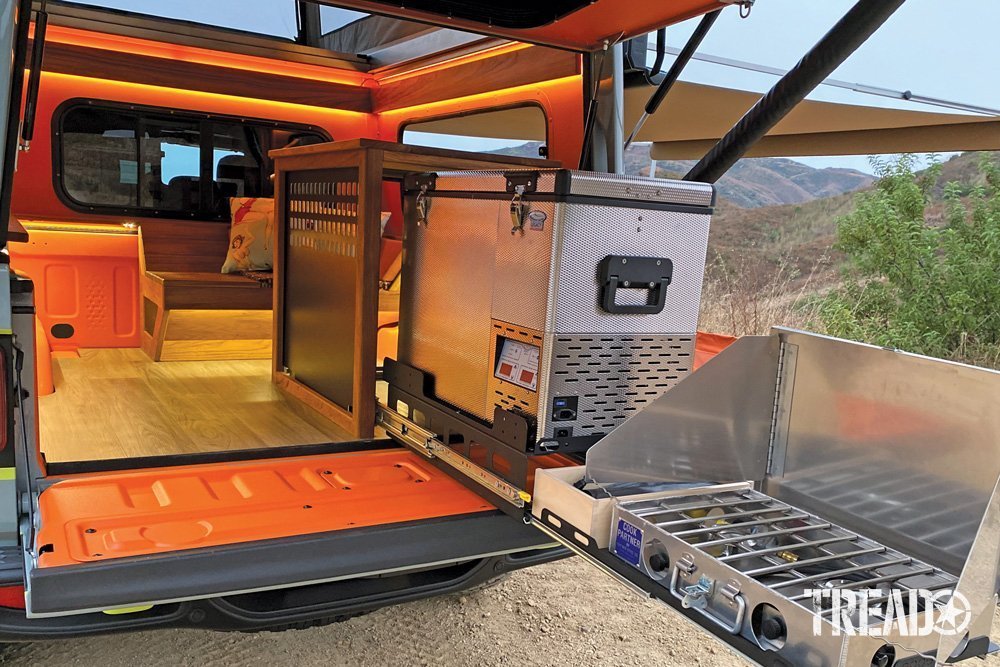 The Gladiator Farout’s living space is like a warm and cozy, with warm lighting and wood/orange accents with slide out fridge and stove.