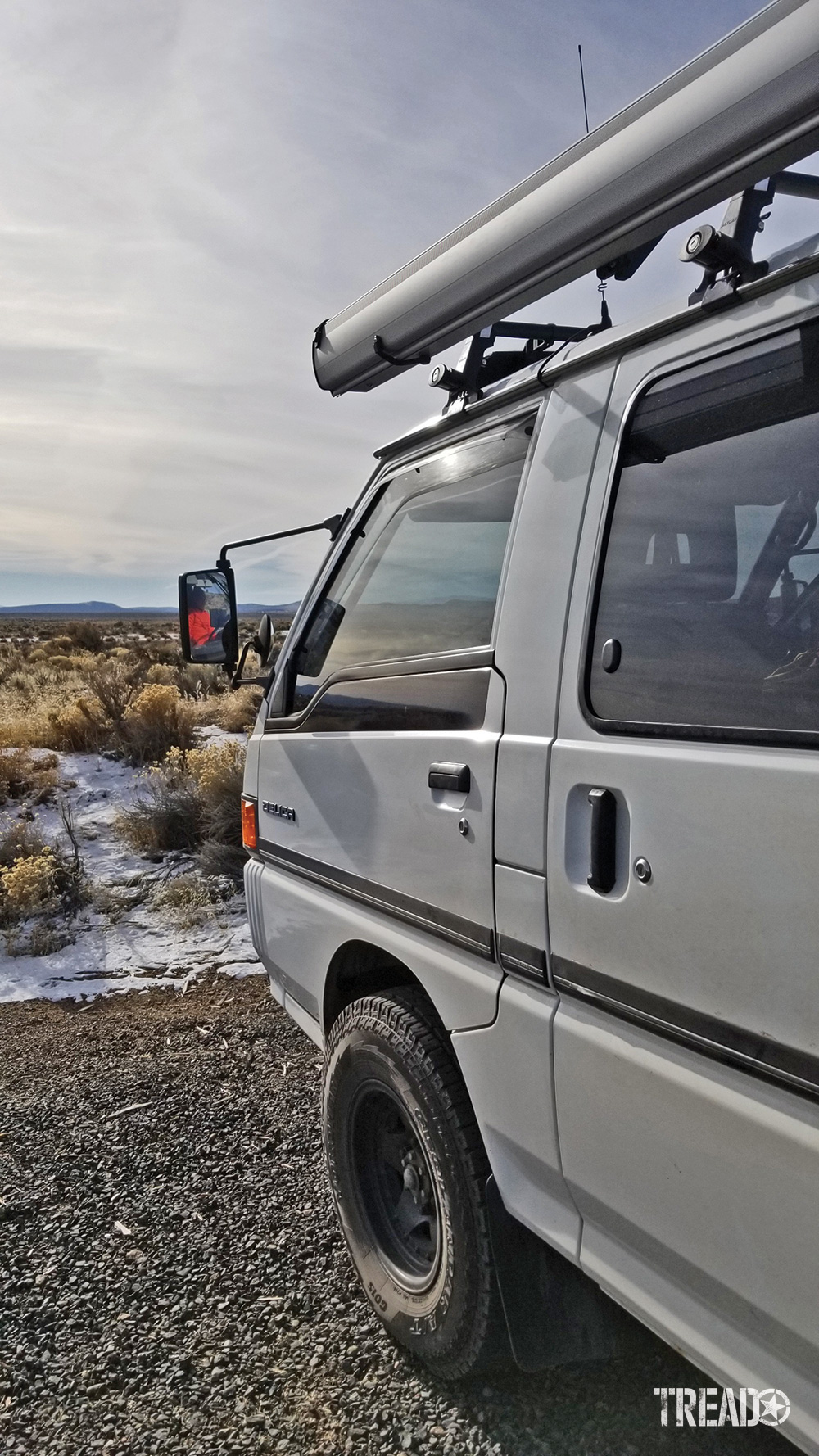 Driver side door view of the white Mitsubishi Delica L300.
