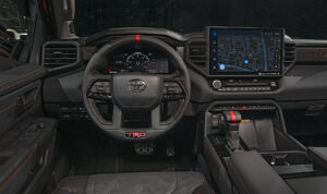 Interior shot of steering wheel and dash of 2022 Toyota Tundra TRD Pro in Solar Octane orange
