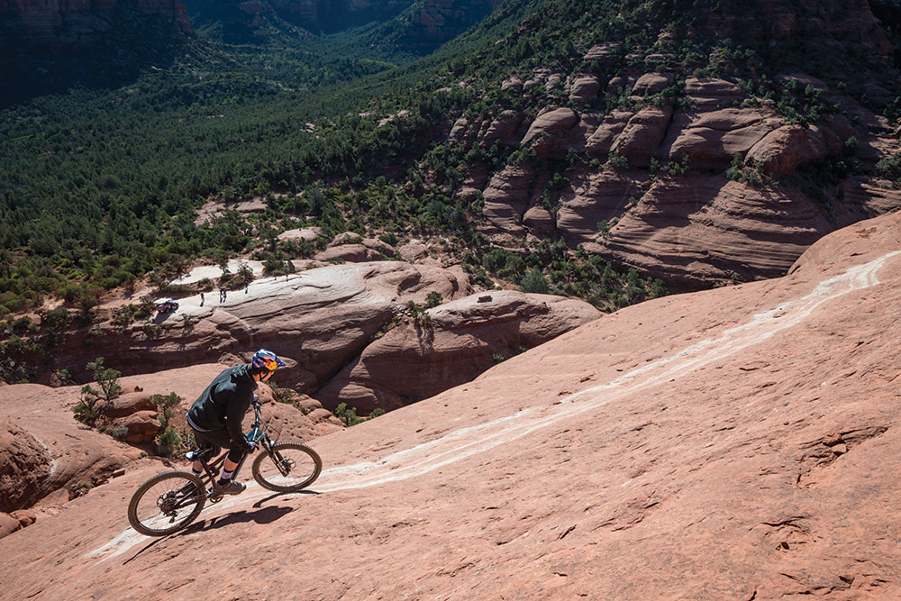 Carson Storch rolls over remote mountain bking trail.