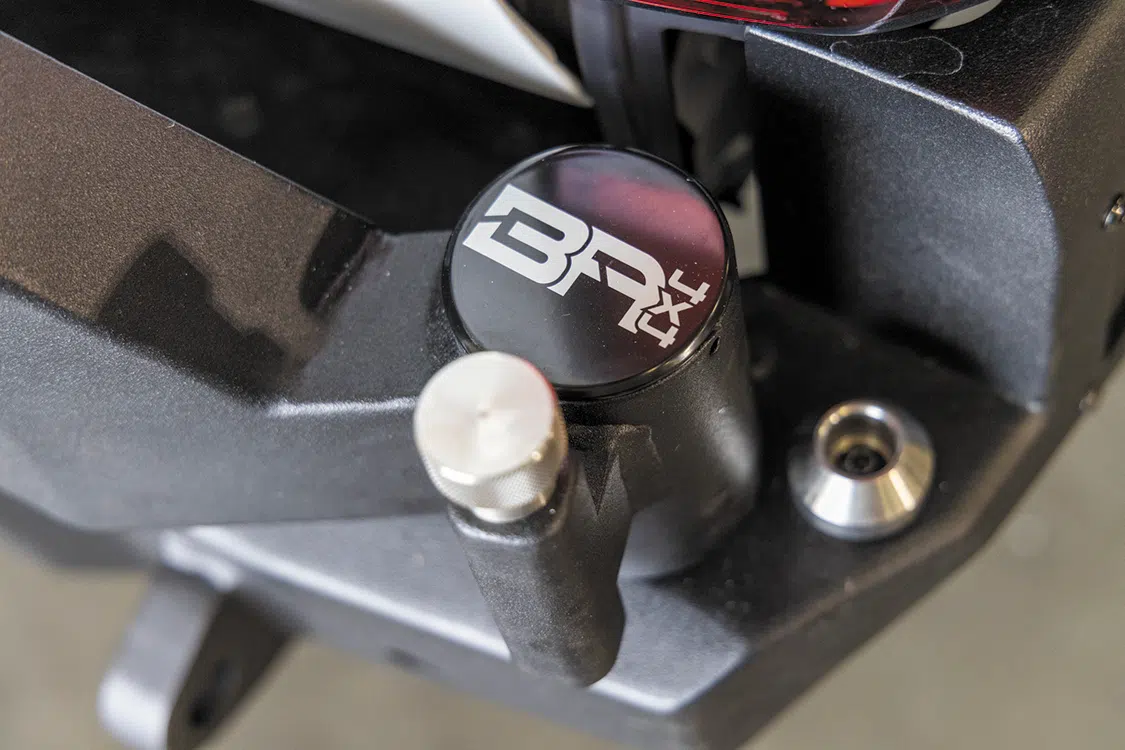 Install the swing arm cap and stop mount