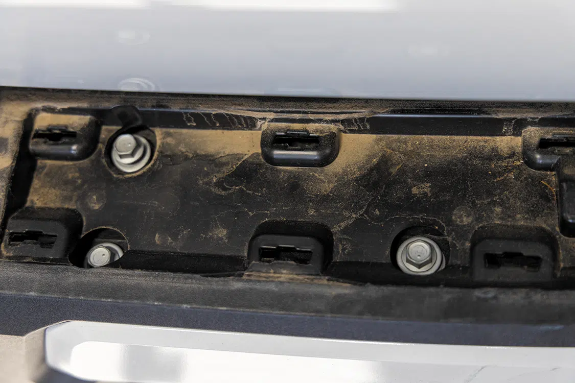 Remove the bolts across the top of the bumper